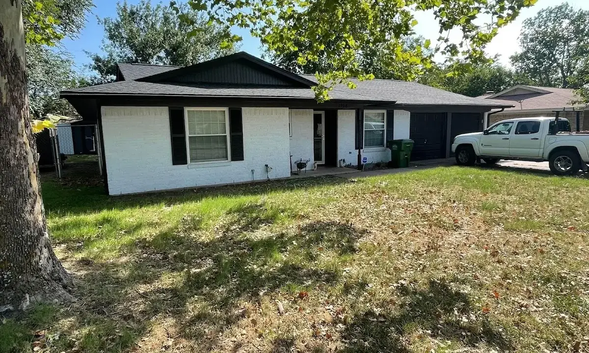 Professional roofing crew working on a residential roof in Milliken